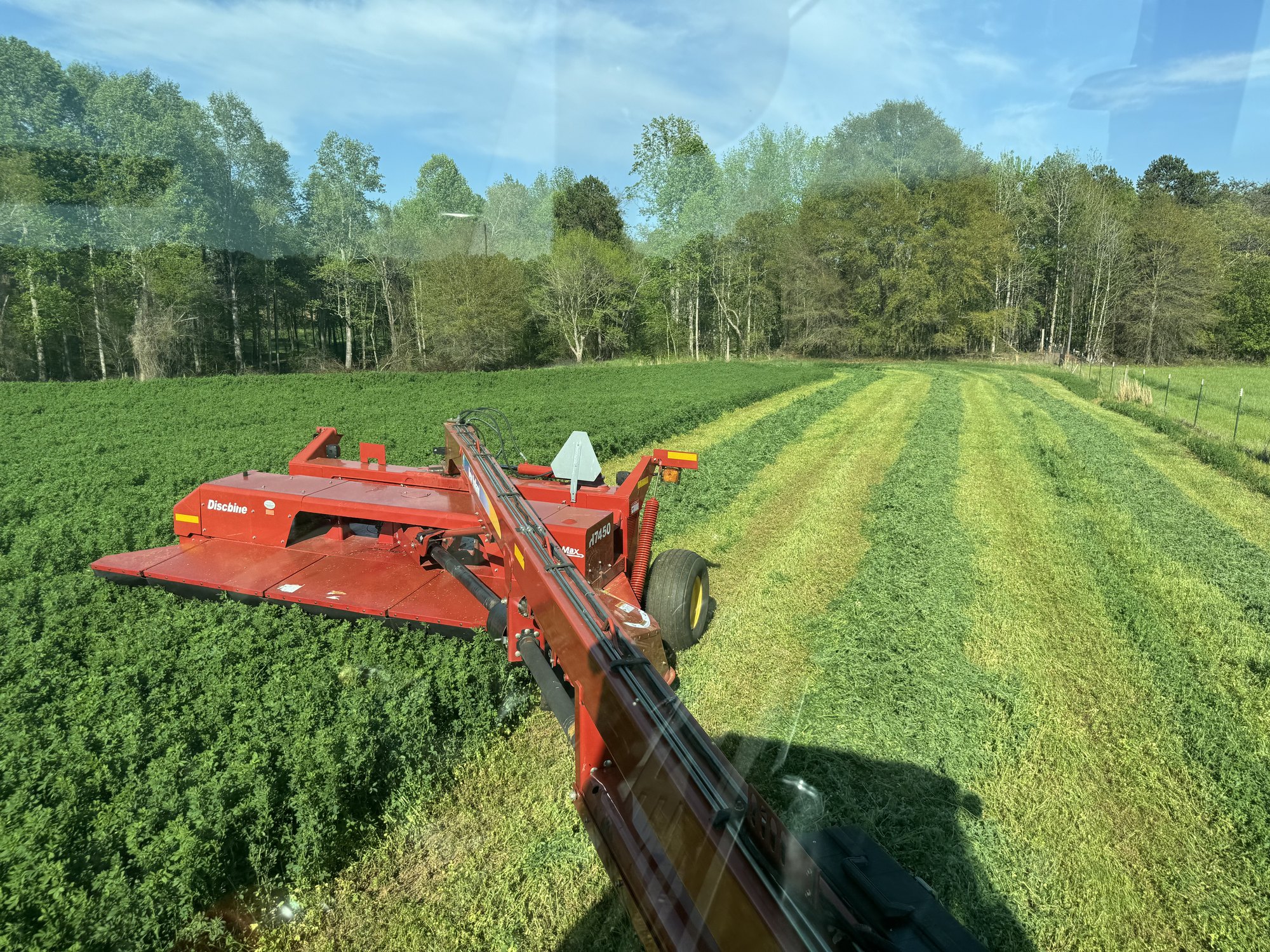 Cutting Alfalfa from the operator's view in the tractor cab